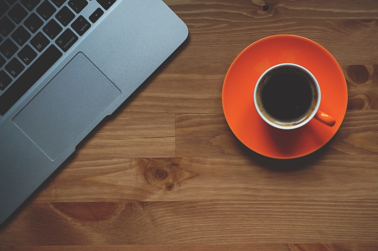 How to Apply for a Canada eTA: First-Time Step-by-Step Guide: laptop and a cup of coffee on a wooden table