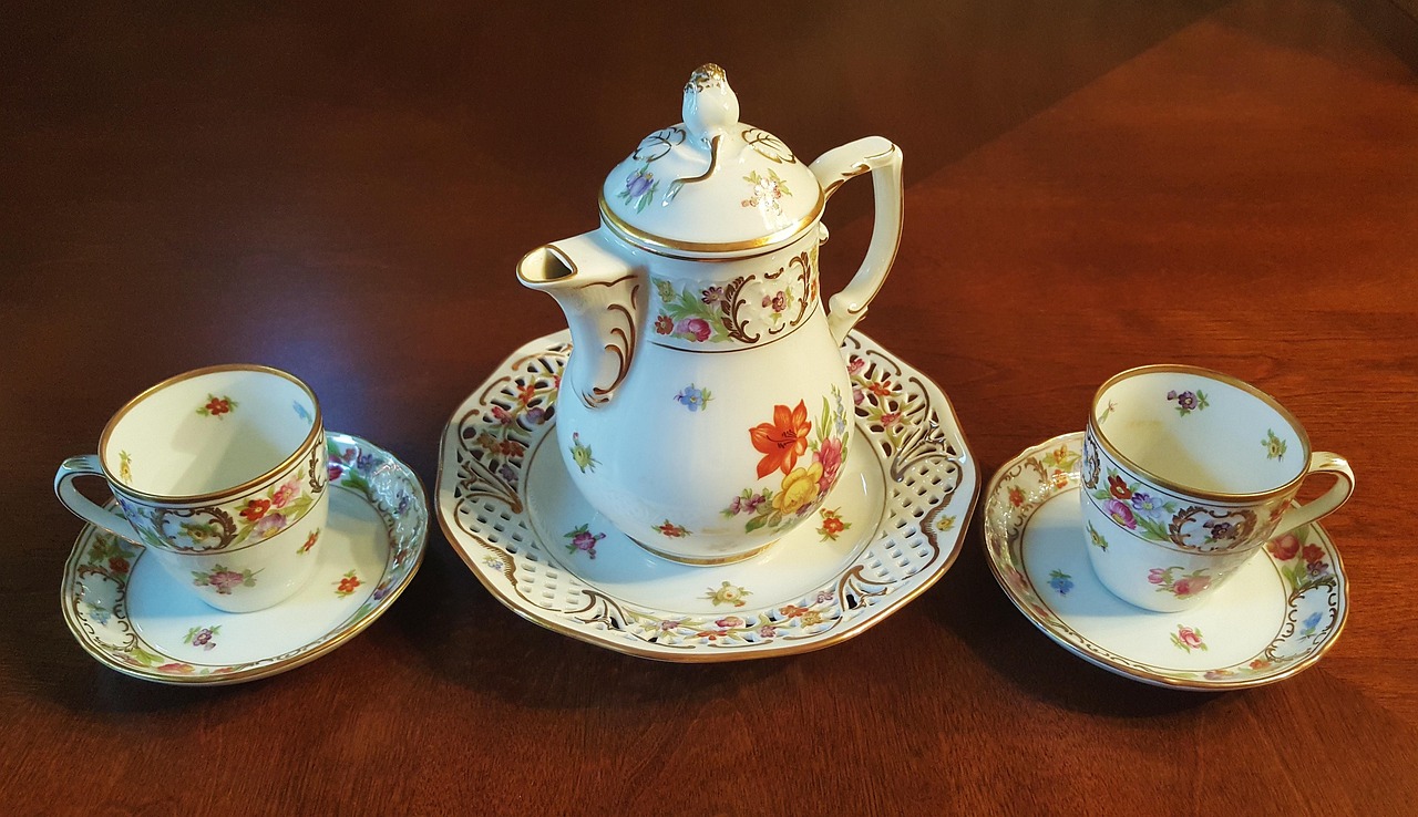 Canada eTA applied twice: two matching porcelain cups with saucers side by side on warm polished wood