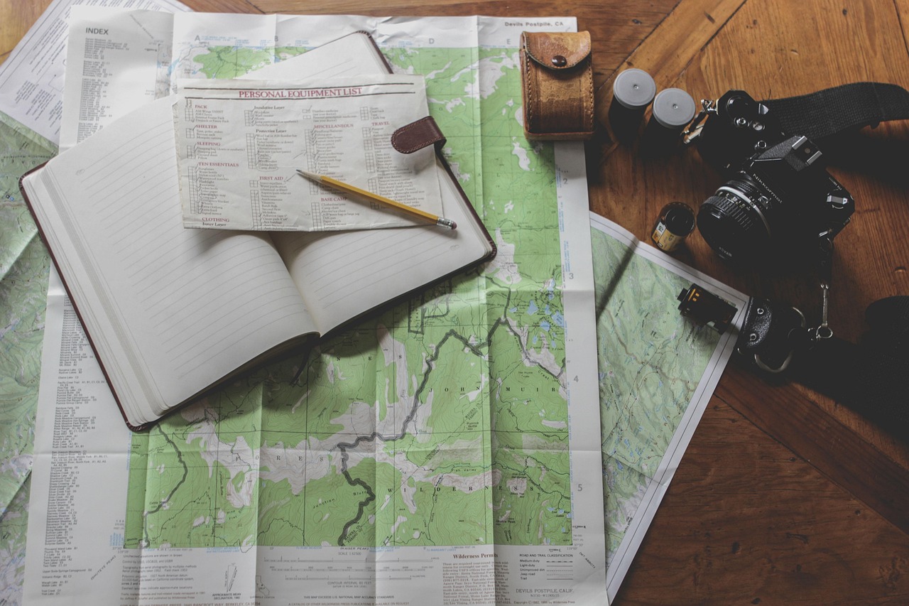 Permanent resident abroad and a Canada eTA: a notebook, map and camera laid out on a wooden table